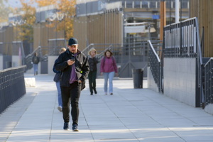 Man walking and watching the phone